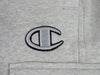 A close up of the Bluetile Skateboards logo on a Bluetile Surplus Champion Sweatpant.