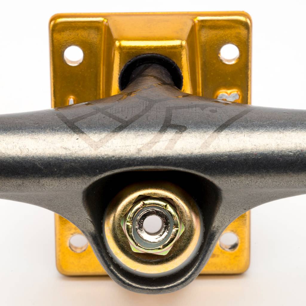 A close up of a THUNDER skateboard with a bolt and nut.