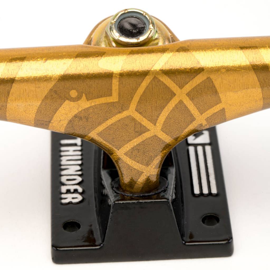 A THUNDER TRUCKS 24K SONORA 148 (SET OF TWO) skateboard with a black design on it.