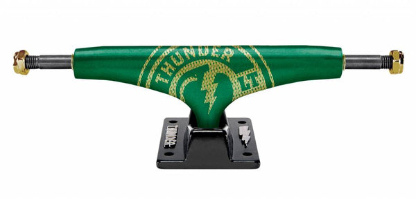 A green THUNDER TRUCKS 147 GOLDSTRIKE LT GRN/BLK skateboard truck on a black background.