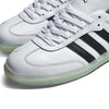 A pair of white ADIDAS JASON DILL SAMBA sneakers with black stripes, inspired by Jason Dill's signature Samba style.