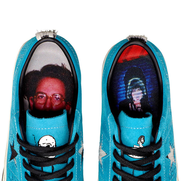 A pair of CONVERSE CONS X PARADISE SEAN PABLO ONE STAR PRO OX RAPID TEAL with a picture of a man's face on them.