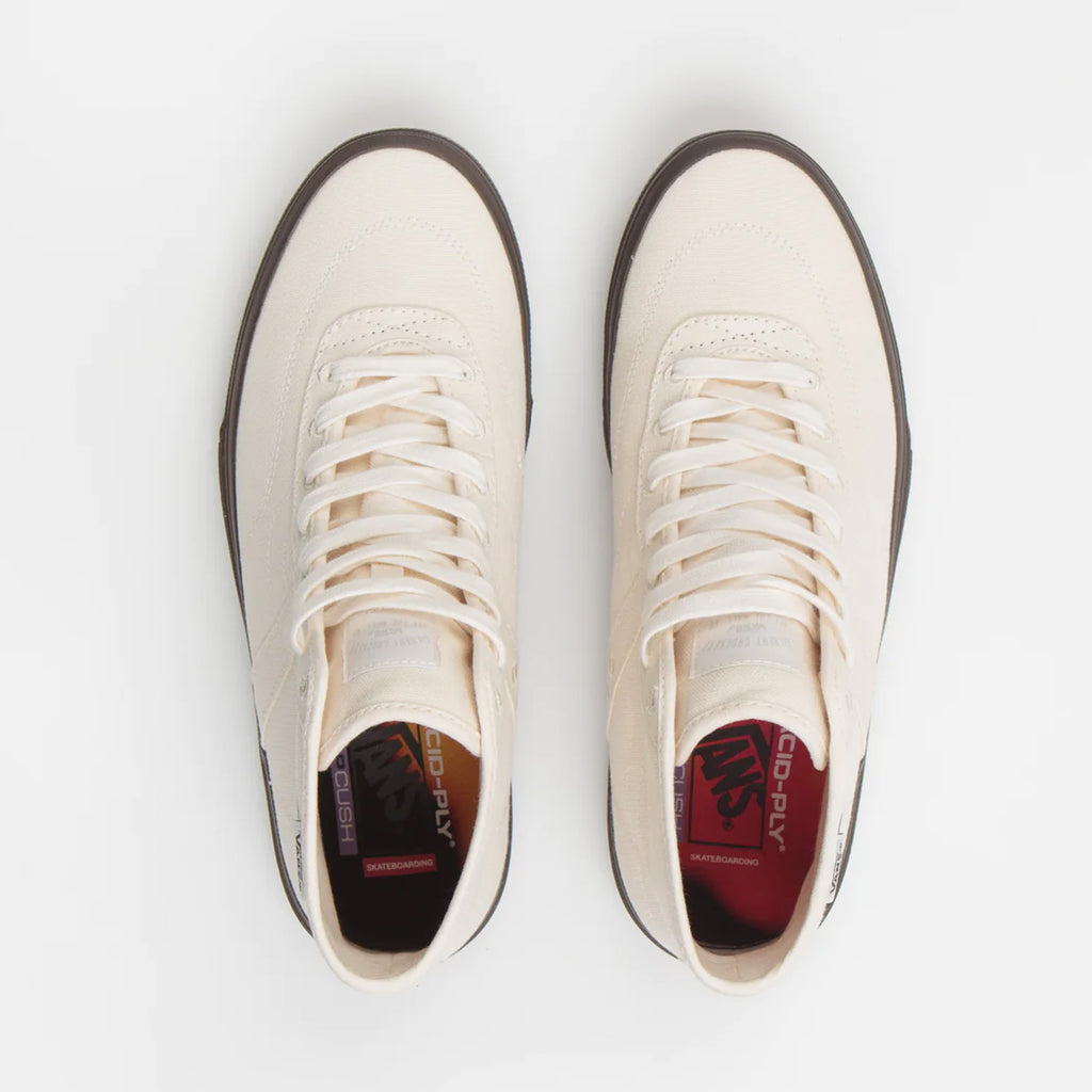A pair of VANS SKATE X QUASI CROCKETT HIGH DECON WHITE sneakers on a white surface.