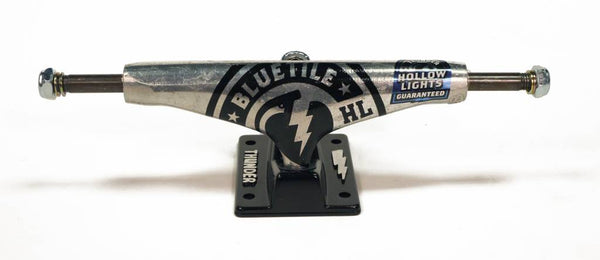 A THUNDER skateboard truck with a logo on it.