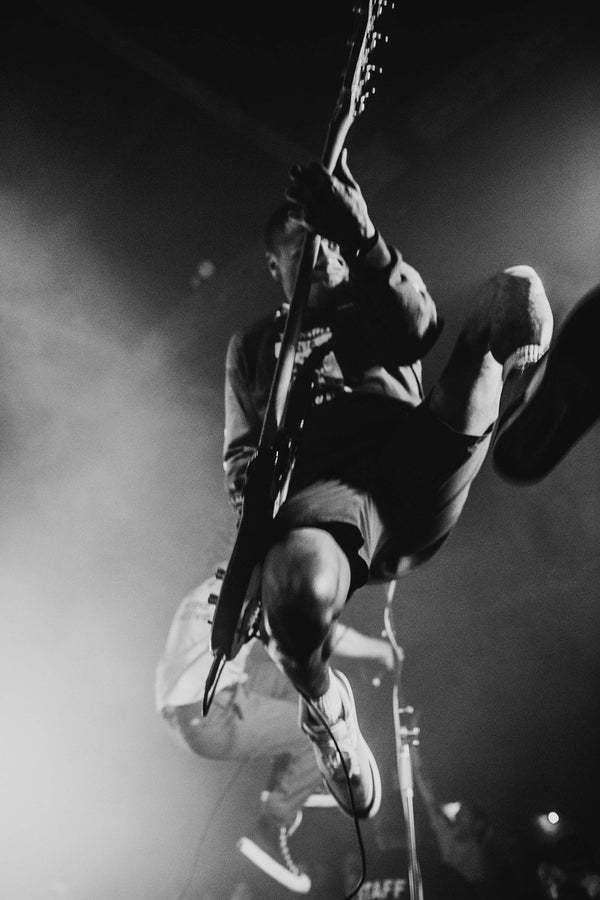 A Turnstile by Savannah Bockus photo print of a man playing a guitar. (Brand Name: Bluetile Skateboards)