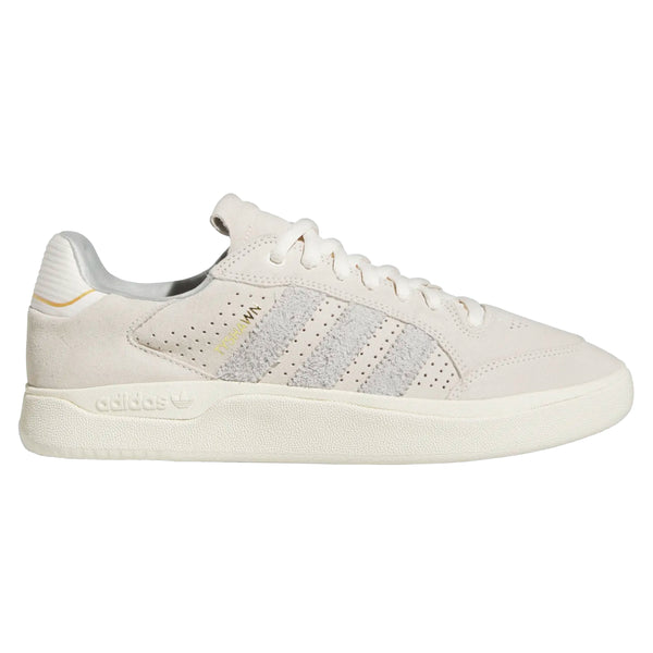 A white ADIDAS Tyshawn Low Chalk White/Grey One/Cream White sneakers with a yellow stripe.