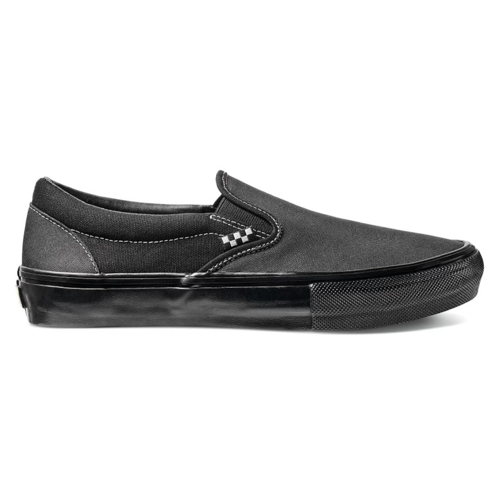 A black slip on with a black sole and a checkered tag on the side.