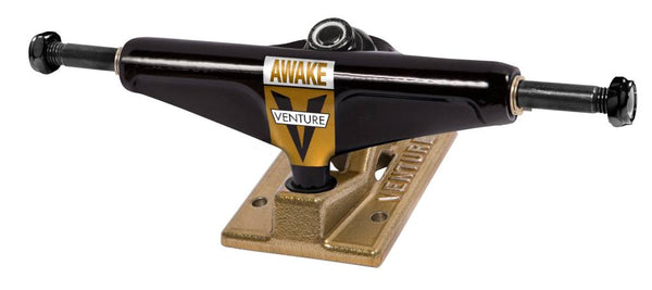 A VENTURE TRUCKS OG AWAKE (SET OF TWO) BLACK / GOLD skateboard truck on a white background.