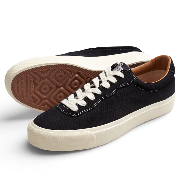 A pair of LAST RESORT AB VM001 CANVAS BLACK/WHITE sneakers with white soles.