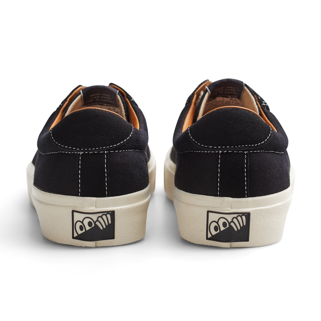 A pair of LAST RESORT AB VM001 CANVAS BLACK/WHITE sneakers with a white logo on the side.