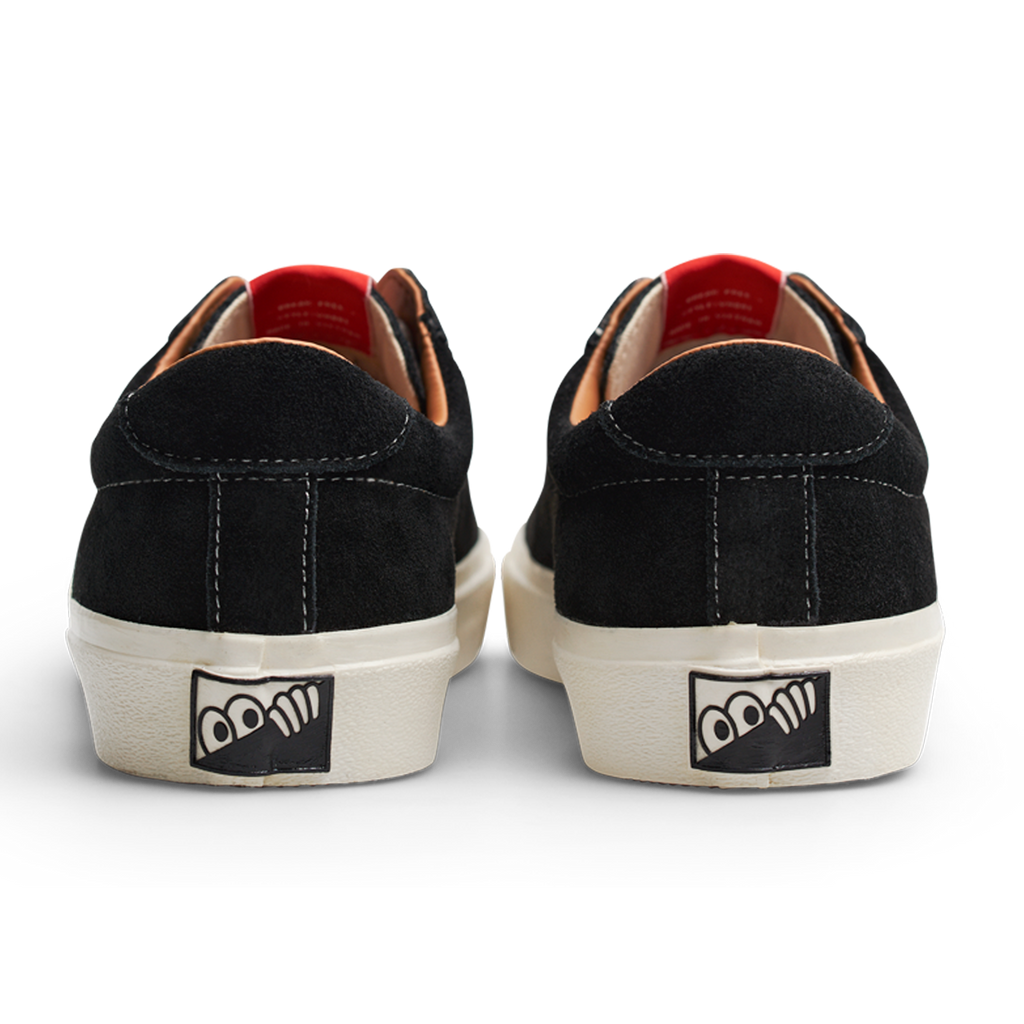 A pair of black LAST RESORT AB VM001 SUEDE BLACK/WHITE sneakers with a red Last Resort AB logo on the side.