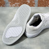 A pair of white Vans SKATE WAYVEE sneakers featuring durable Wafflecup construction, placed on a smooth concrete floor.