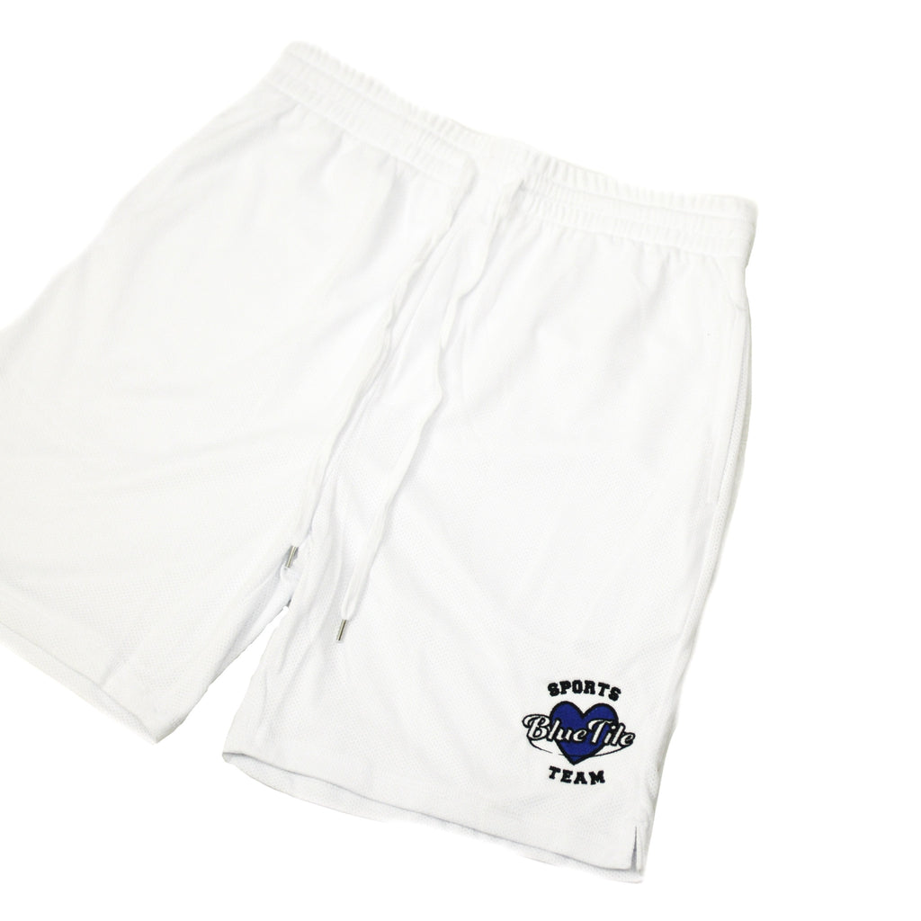 A BLUETILE SPORTS BASKETBALL SHORTS WHITE with a blue logo on it, made by Bluetile Skateboards.