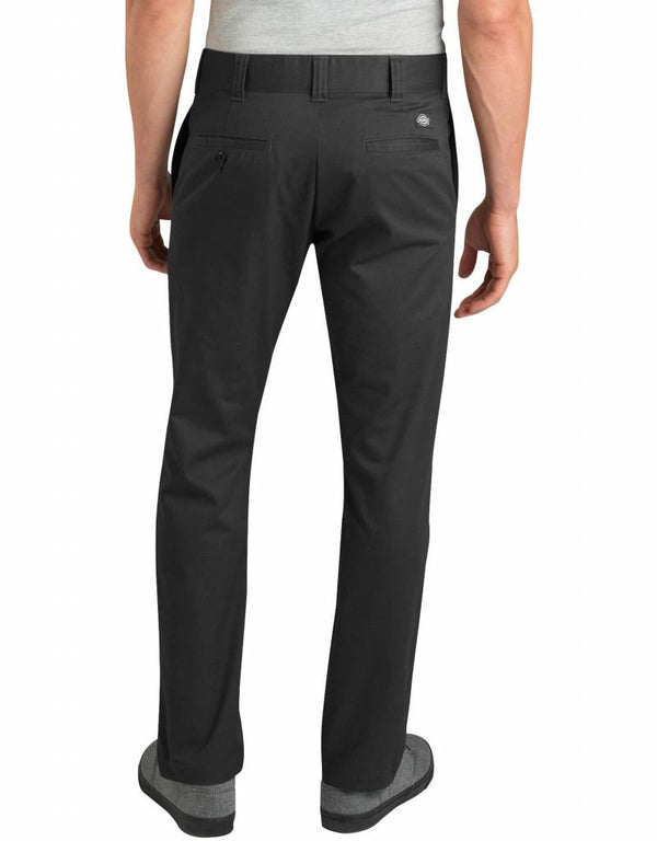 A person is shown from the back, standing with arms relaxed at their sides, wearing a light gray shirt and black Dickies '67 Twill Pant with Pivot-Tek by DICKIES.