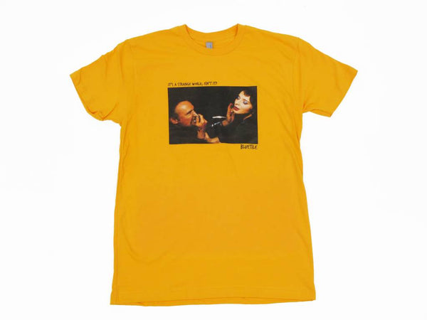 A Bluetile Skateboards "STRANGE WORLD" T-SHIRT GOLD with an image of a woman and a man.